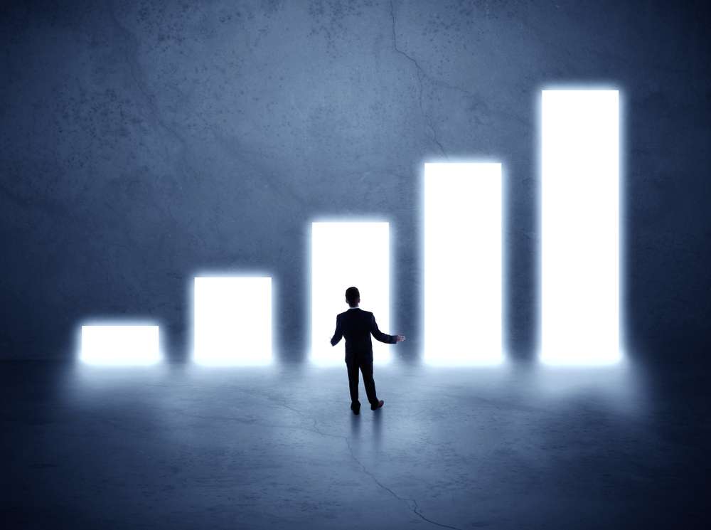 Businessman standing in the front of growth chart of profits Businessman standing in the front of growth chart of profits